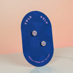 a blue backer card holding a pair of modern and minimal pastel purple hexagon earrings