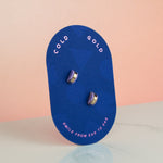 studio 54 inspired geometric stud pastel marble earrings displayed on blue pill shaped card
