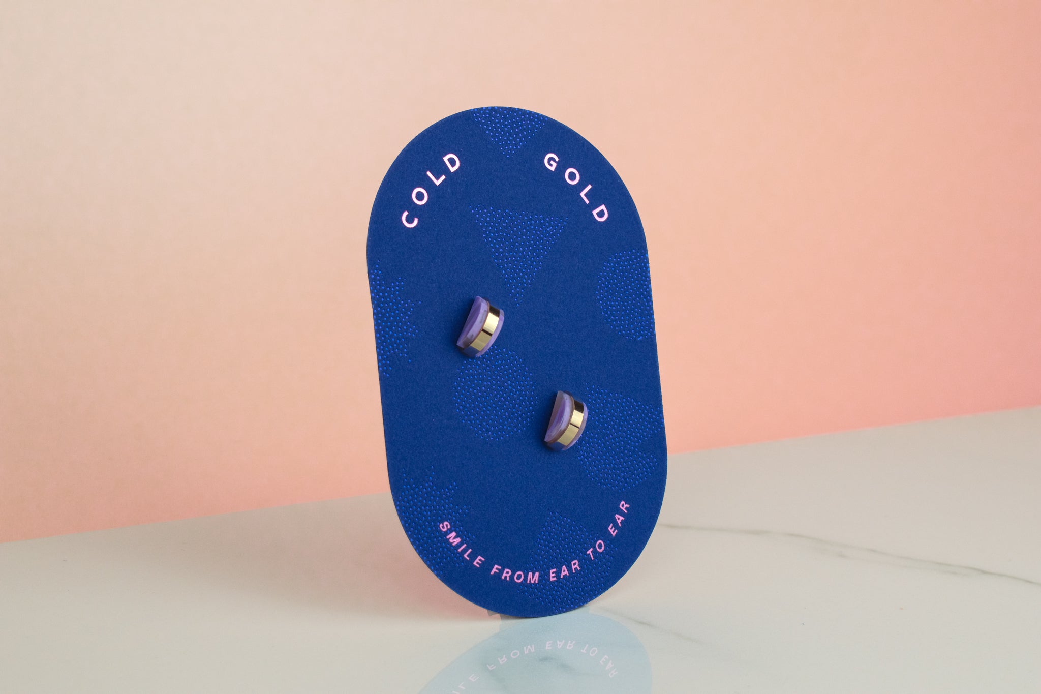 studio 54 inspired geometric stud pastel marble earrings displayed on blue pill shaped card