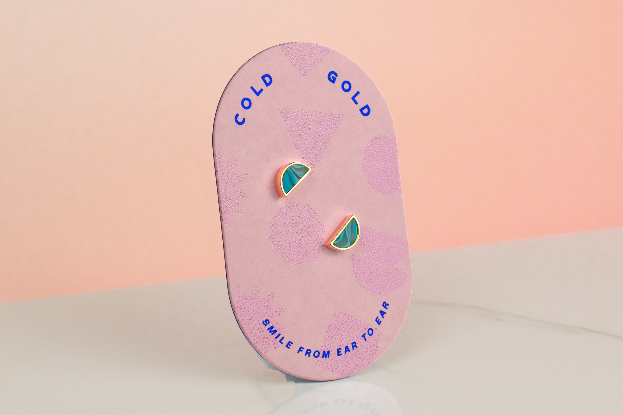 a pill shaped backer card showing blue topaz quartz gemstone clay and 14k gold plated stud earrings set