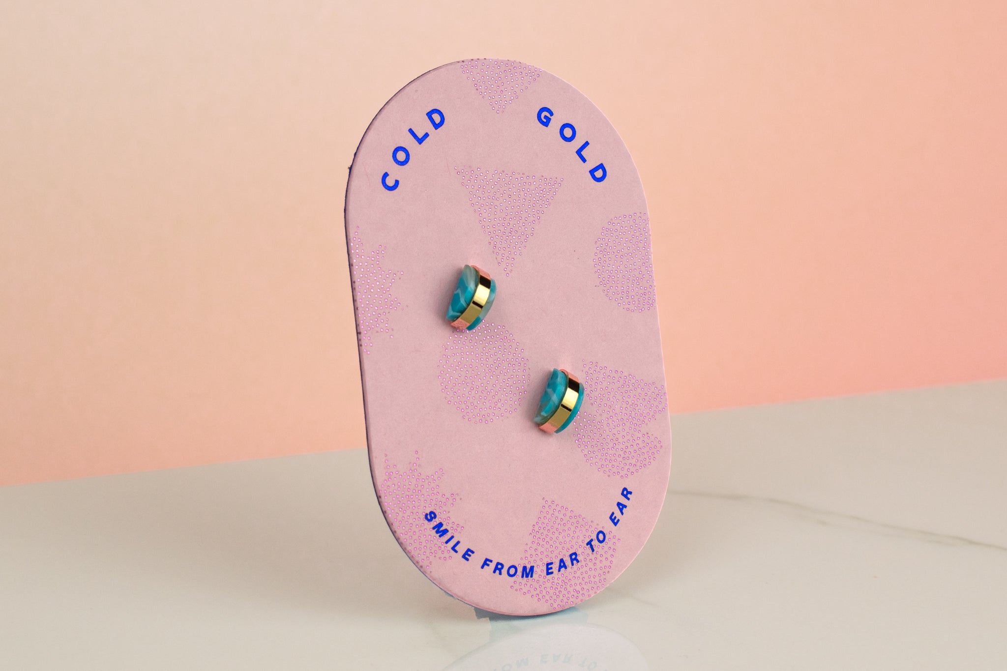 pink backer card holding aquamarine earrings geometric gold-plated stud earrings march birth stone present jewelry