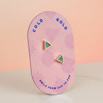 a bubblegum pink card showing a tiny triangle earring set in clay marbled to look like aquamarine crystal gemstone