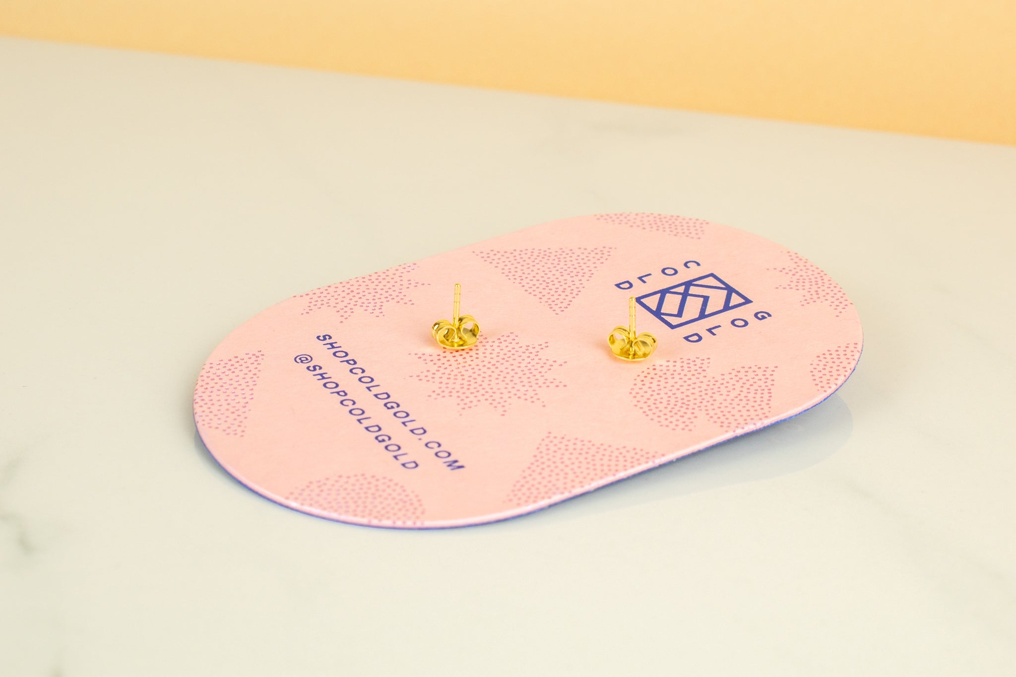 back of pink cold gold earring backer card