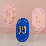 birth of venus collection photographed together pearl studs, pearl hoops, and pearl drop earrings