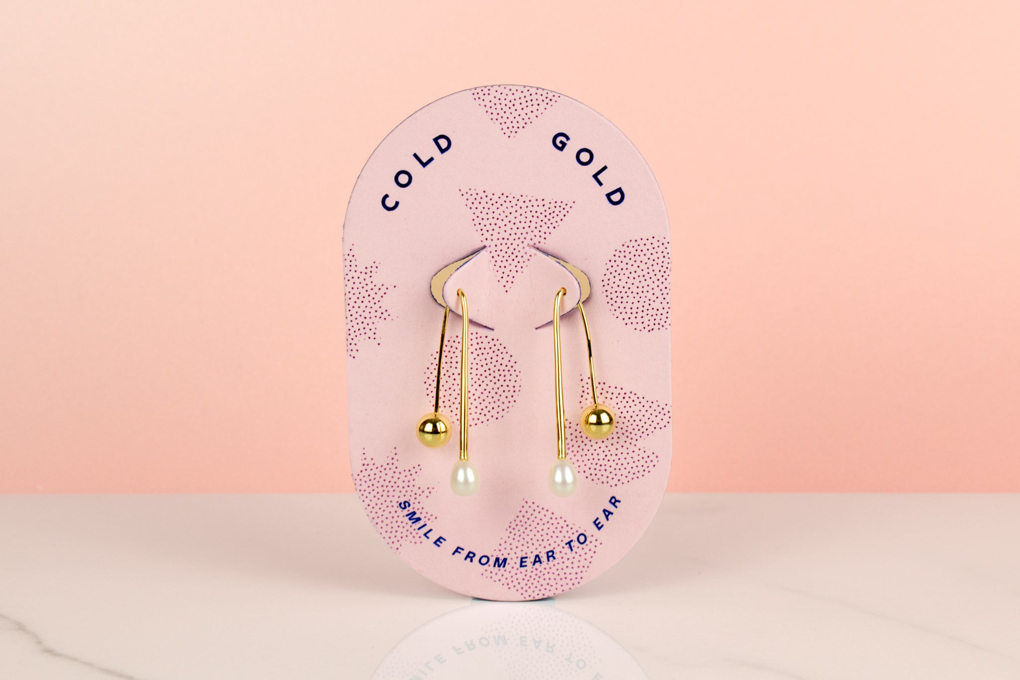 pink cold gold card displaying gold freshwater baroque pearl drop earrings