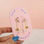 pink card displaying structured threader gold cultured pearl drop earrings