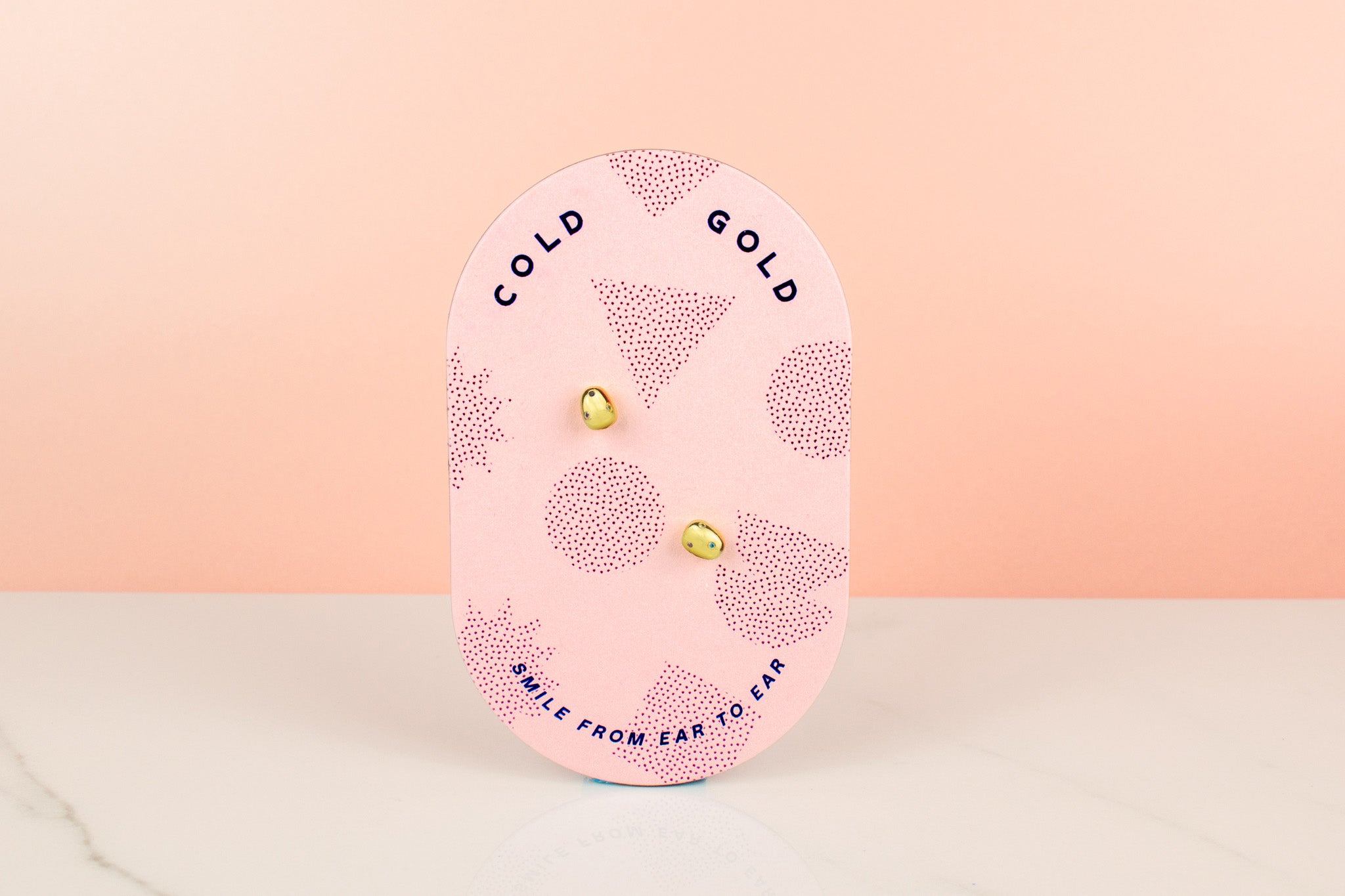 tiny delicate baroque gold pearl earrings with colorful CZ crystal inlay displayed on pink card