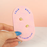 pink cold gold card displaying 14k gold plated pearl earrings embellished with multicolored gemstones