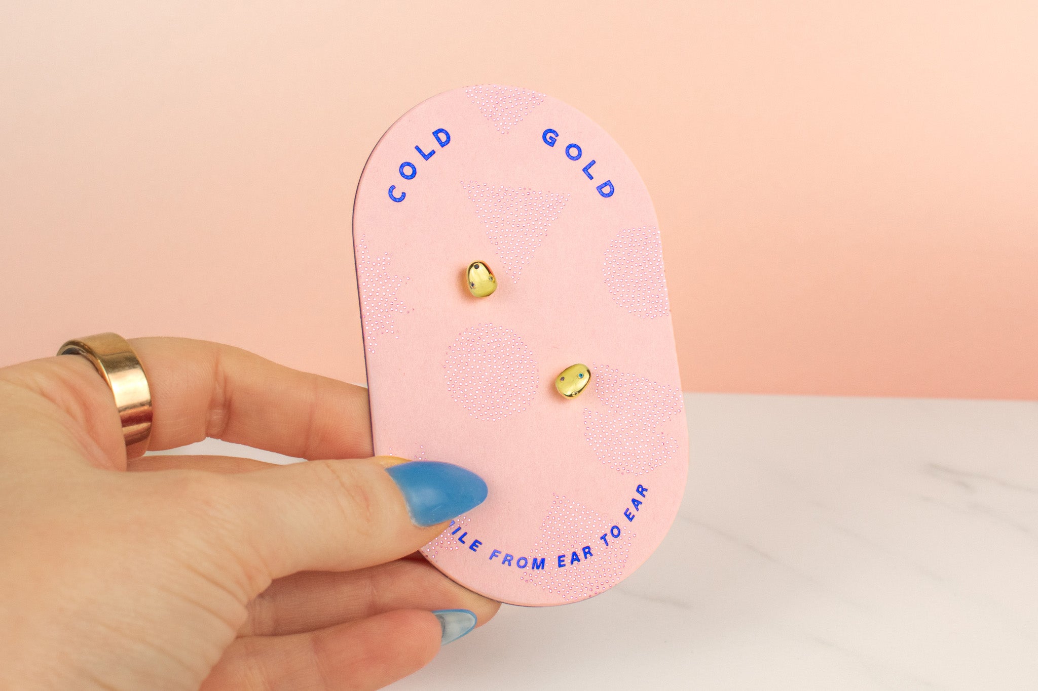 pink cold gold card displaying 14k gold plated pearl earrings embellished with multicolored gemstones