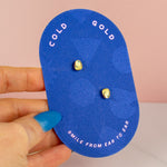 bright blue cold gold earring backer displaying 14k gold plated pearl studs with aquamarine sapphire emerald CZ gemstones