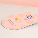 back of pink pill shaped card with cold gold logo