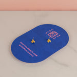 back of blue pill shaped card with cold gold logo