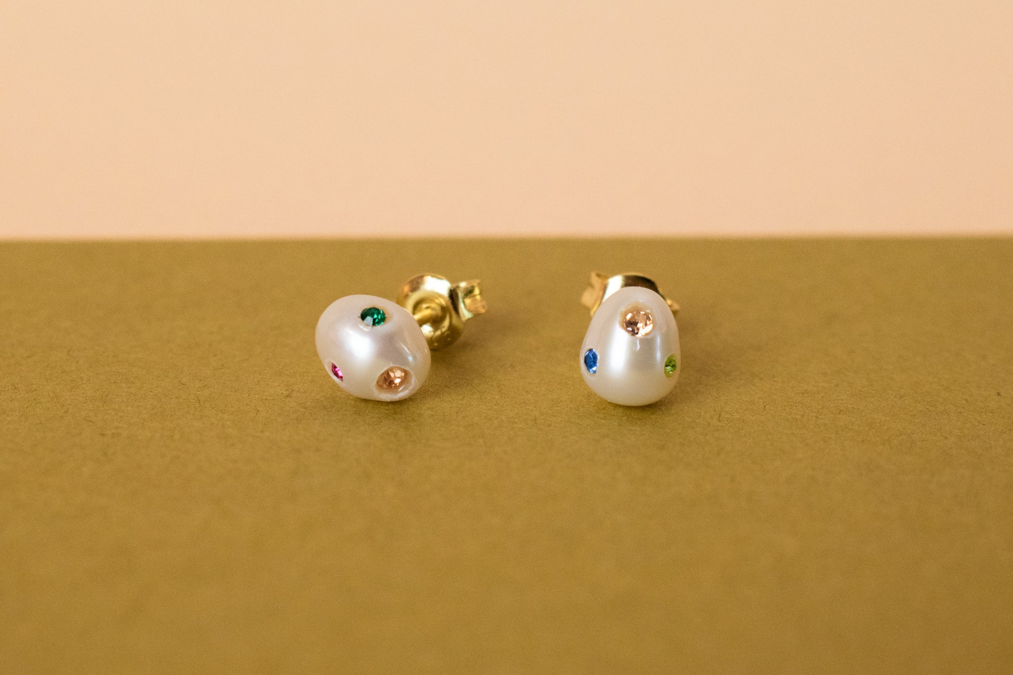 organic shaped freshwater pearl earrings encrusted with apple green, fuschia, rose quartz, emerald gemstones, sapphire gemstones