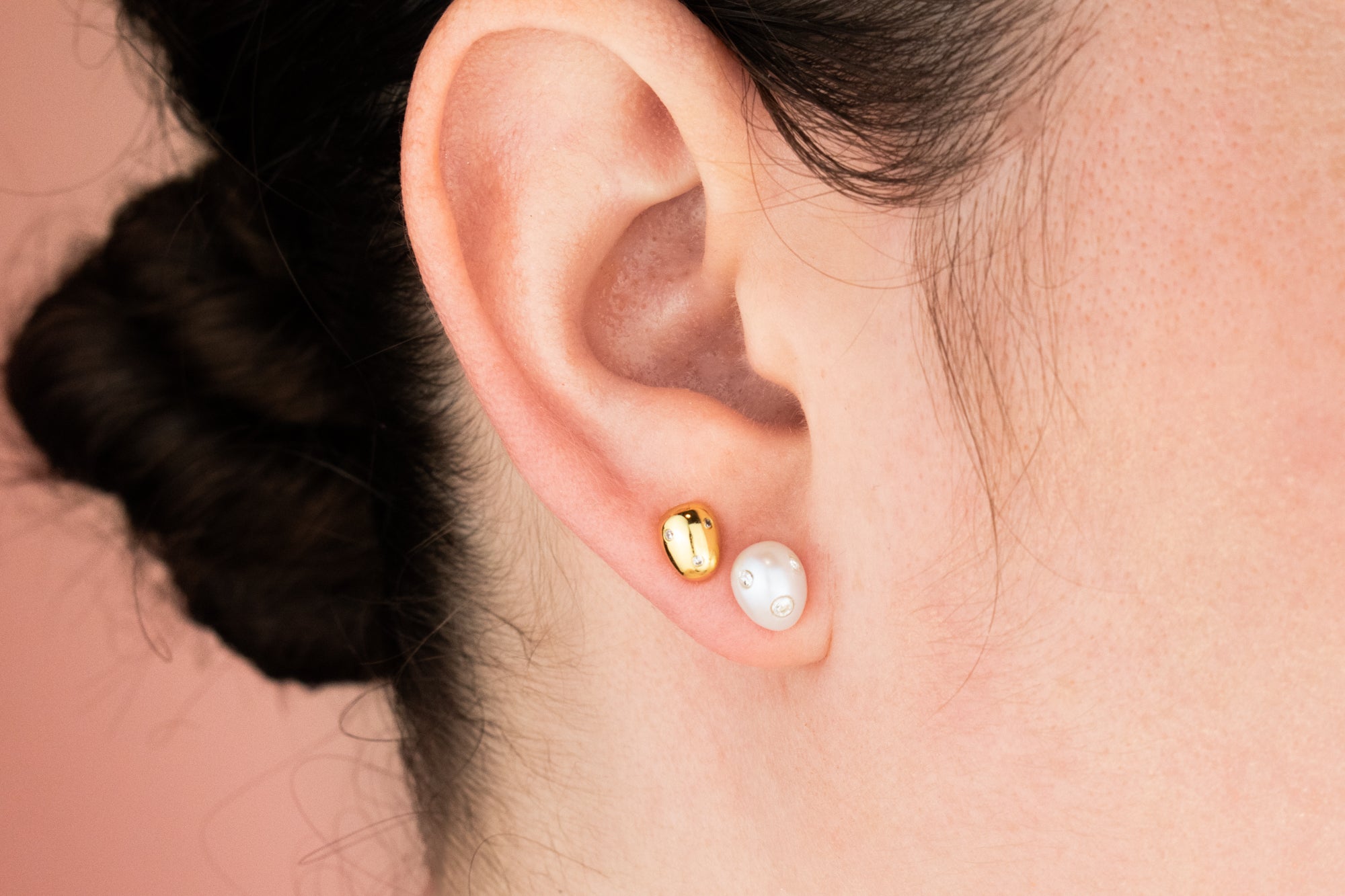 model wearing gold pearl earring in second hole and freshwater pearl with crystals