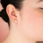 model wearing freeform pearl earring with cz gemstones