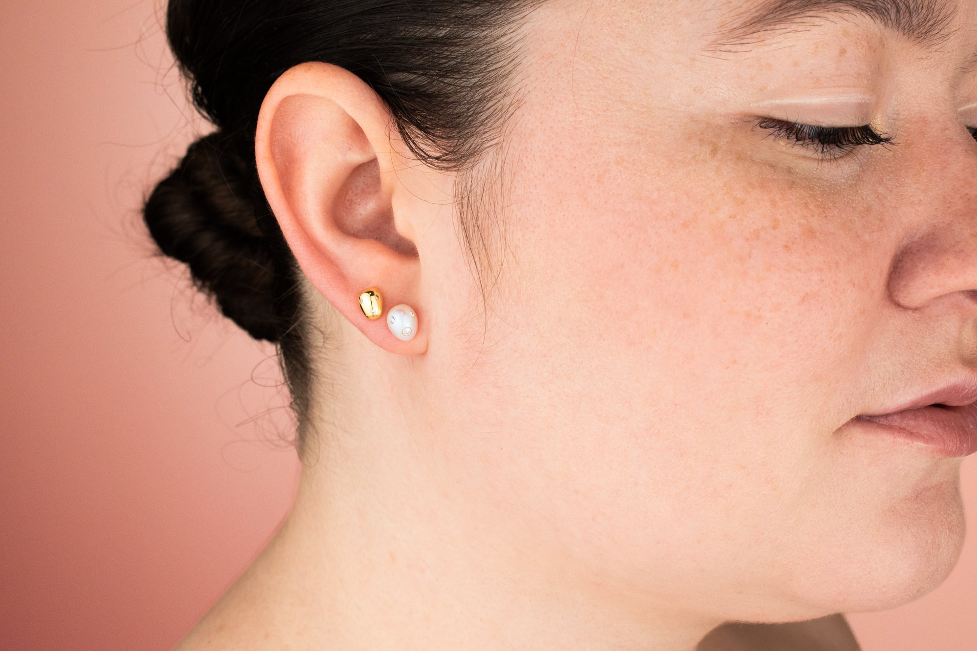 model wearing freeform pearl earring with cz gemstones