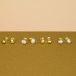 group photo of gold and pearl aura studs encrusted with crystal
 gemstones in varied sizes