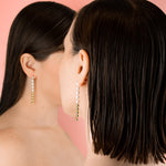 two female models wearing baroque freshwater pearl chain dangly drop earrings
