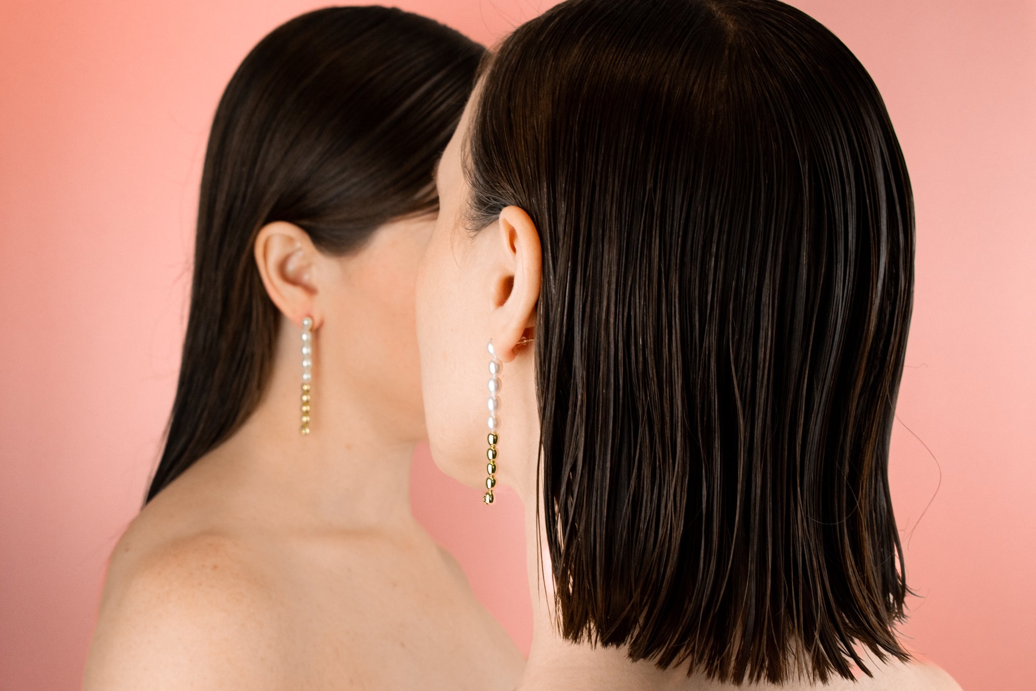 two female models wearing baroque freshwater pearl chain dangly drop earrings 