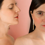 two women modeling baroque freshwater pearl hoop earrings worn down