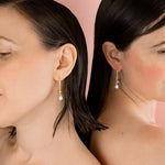 twin models wearing delicate gold open hoop ear wire adorned with single baroque freshwater pearl
