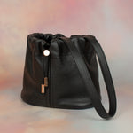 pebbled grain leather bucket bag with drawstring closure and gold hardware