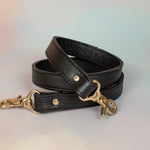 matching black leather adjustable strap with gold hardware