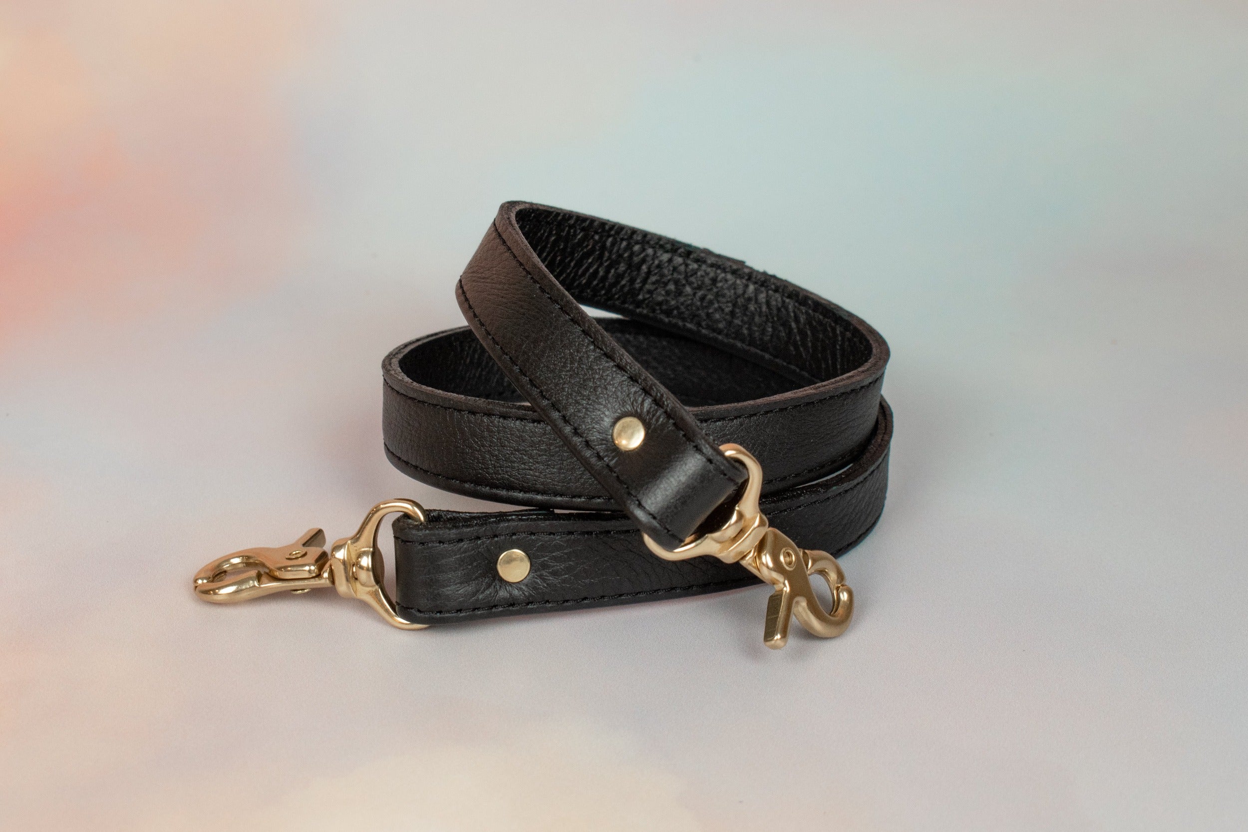 matching black leather adjustable strap with gold hardware