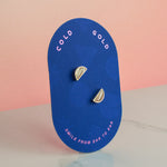 blue card displaying pair of white striped handmade crystal earrings