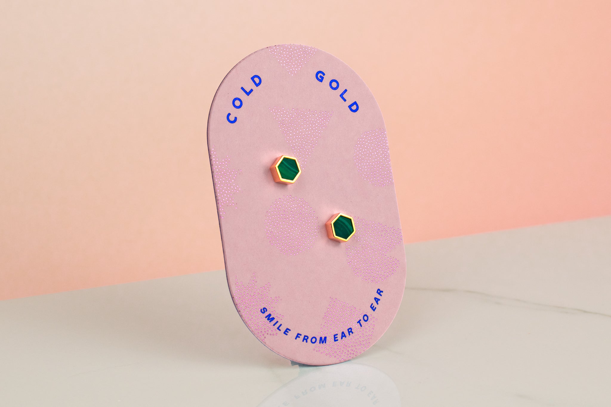 light pink cold gold card displaying forrest green clay hexagon gold plated stud