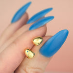 close up of 14k gold plated pearl earrings encrusted with aquamarine, chartreuse, marigold, black gemstones