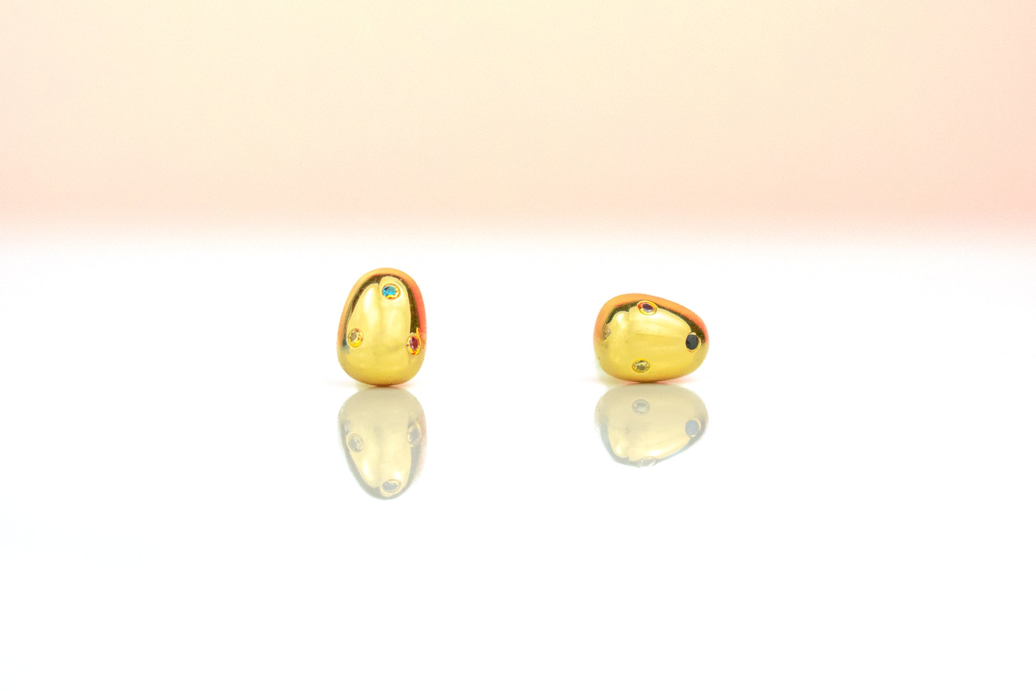 close up of 6mm golden pearl earrings embellished with rainbow gemstones sterling silver posts