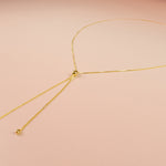 modern gold bolo necklace with adjustable slider bead and teardrops endcaps