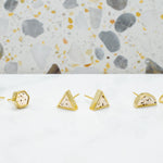 three pairs of dalmatian style terrazzo geometric gold stud earrings in hexagon, triangle, and half moons