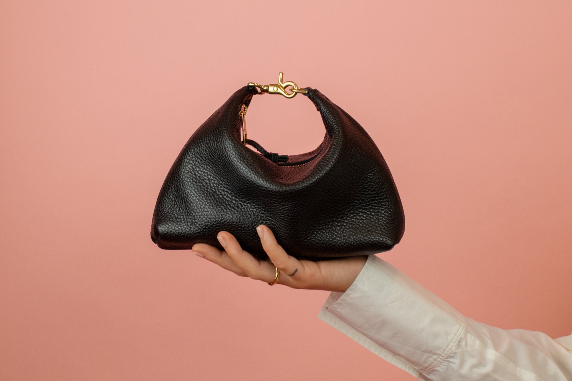 mini black leather crescent handbag with convertible design and gold hardware