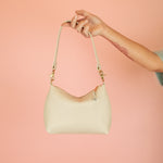 modern slim leather shoulder bag with convertible design and gold hardware in ivory leather
