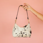cowprint slim leather crescent shoulder bag with detachable black leather strap and gold hardware