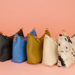 group photo of 5 leather handbags handmade by cold gold in genuine pebbled leatherwith detachable straps and gold hardware