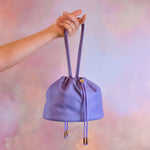 medium sized slouchy muted leather purple drawstring handbag