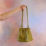 versatile slouchy pebbled olive green leather shoulder handbag drawstring closure gold hardware