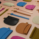slim leather cardholder and keychains laying flat in assorted colors, chic pouch wallets with snap closure card pocket