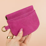 hand holding small simple handmade leather wallet card case wristlet with gold hardware