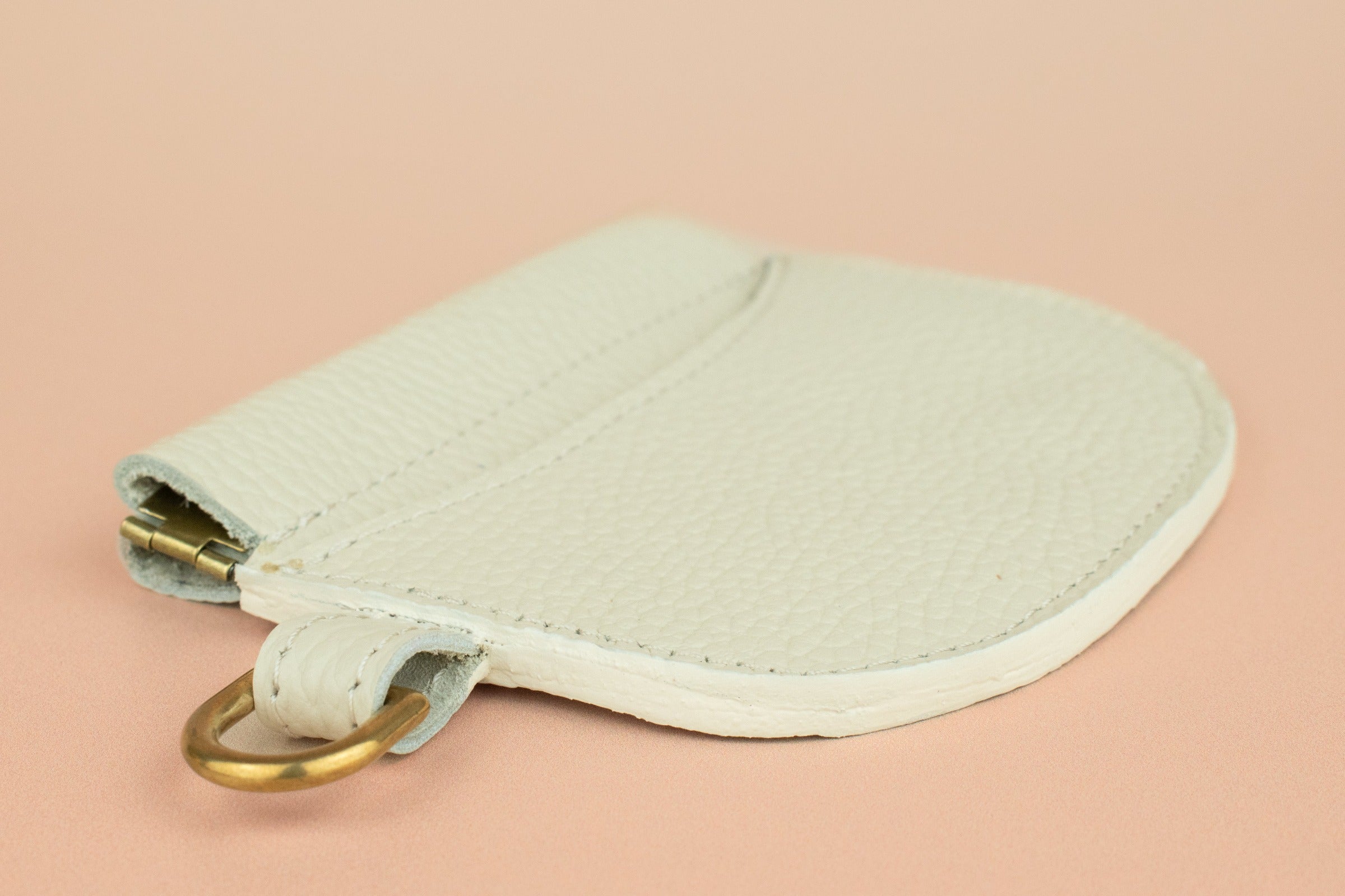 slim bone white leather wallet wristlet with squeeze clasp and gold hardware