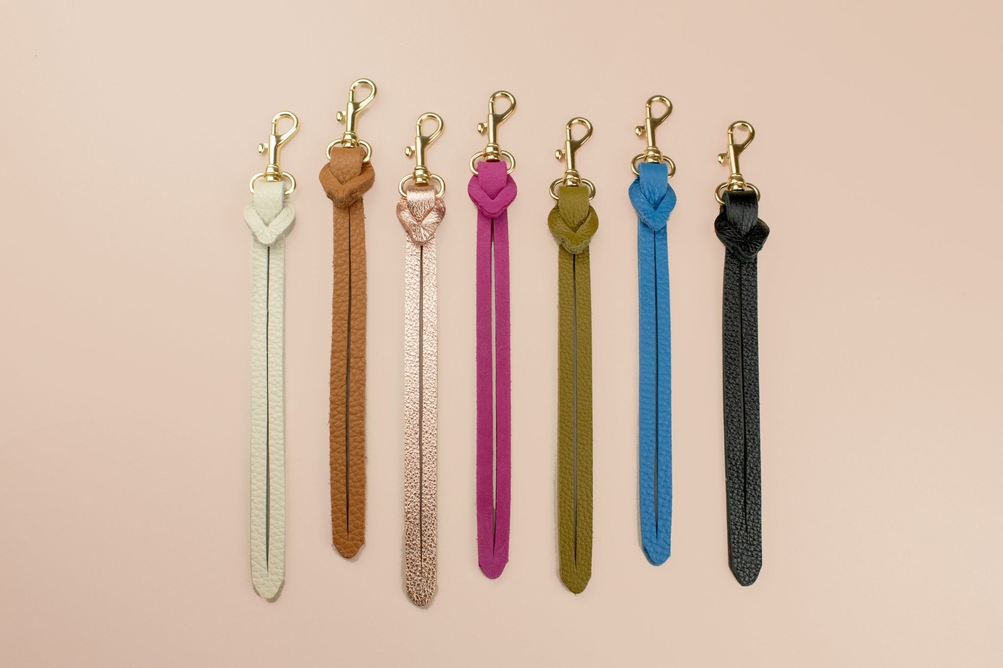 a series of colorful genuine handmade leather keychains