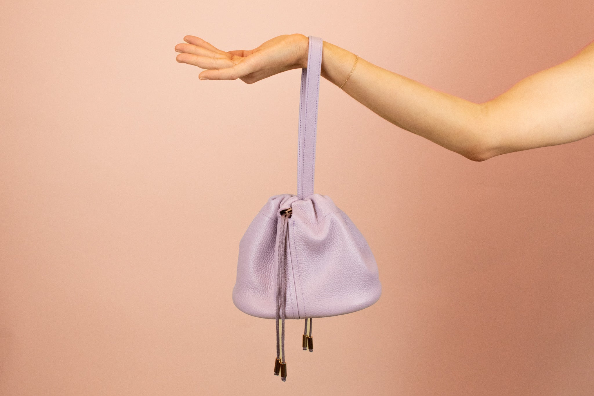 purple leather slouchy handbag with adjustable matching straps and drawstring closure