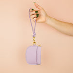 models arm holding up lilac loop keychain wristlet attached to matching leather card wallet with exterior pocket