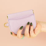 model holding hand stitched pale purple pebbled leather slim cardholder
