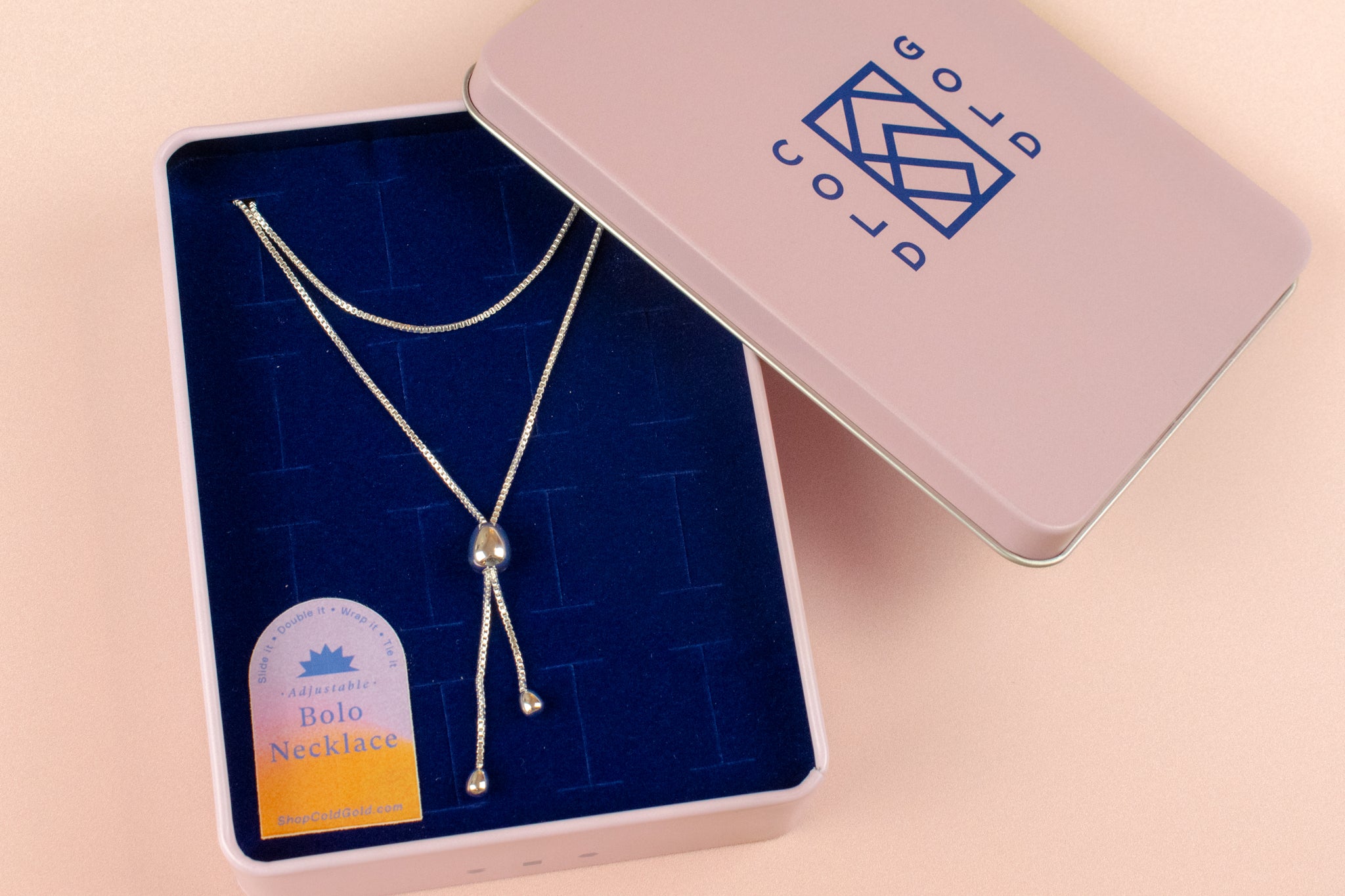 modern formal bolo tie in sterling silver with adjustable sliding pendant photographed inside cold gold jewelry box