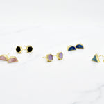 Pairs of new geo stud earrings in 14k gold, shown in triangle, half moon, and hexagon shapes