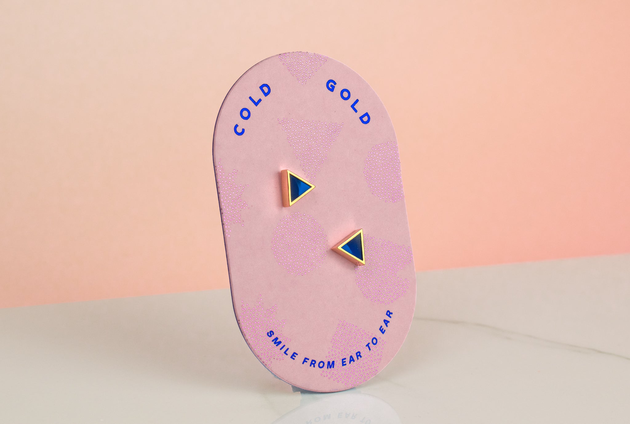 pink card displaying pair of geometric handmade sapphire polymer clay earrings 14k gold plated
